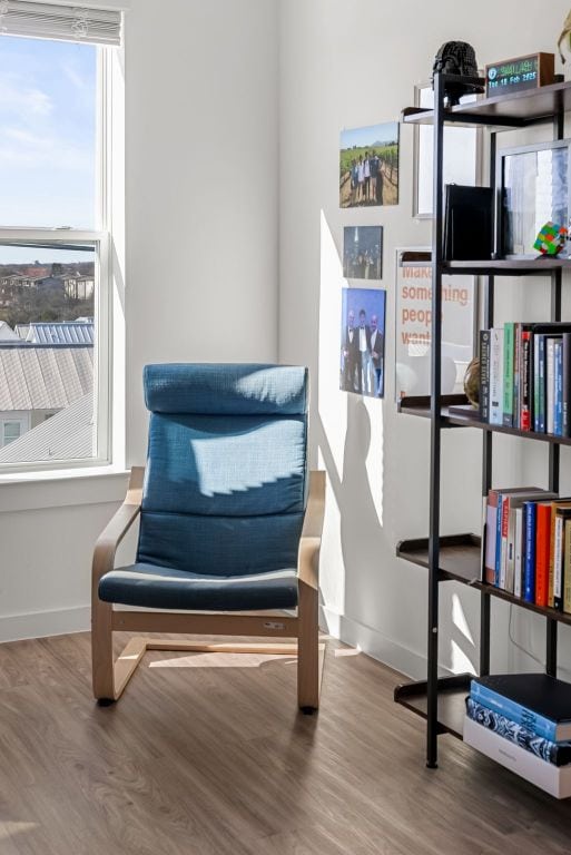 sitting room featuring baseboards and wood finished floors