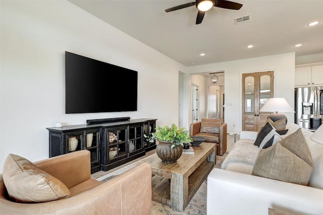 living area featuring recessed lighting, visible vents, and ceiling fan