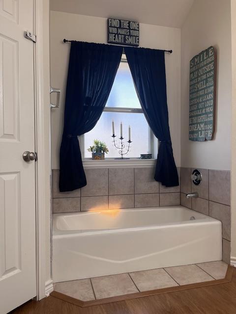 bathroom featuring a bathtub and tile patterned flooring