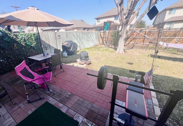 view of patio featuring outdoor dining space, area for grilling, and a fenced backyard