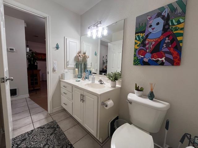 bathroom with vanity, toilet, and tile patterned floors