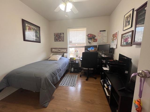 bedroom with wood finished floors and a ceiling fan