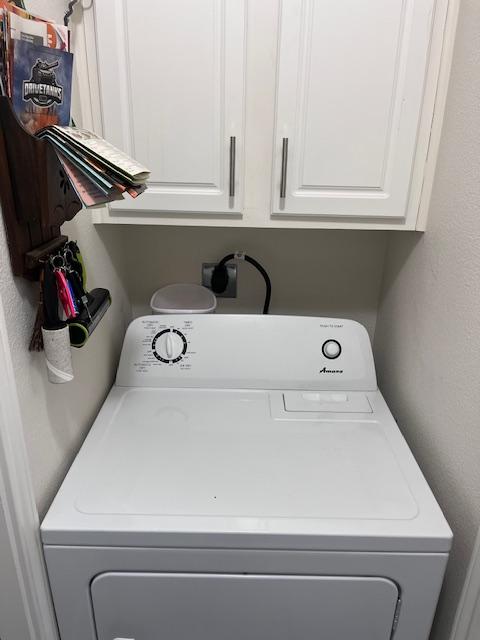 laundry room with washer / clothes dryer and cabinet space