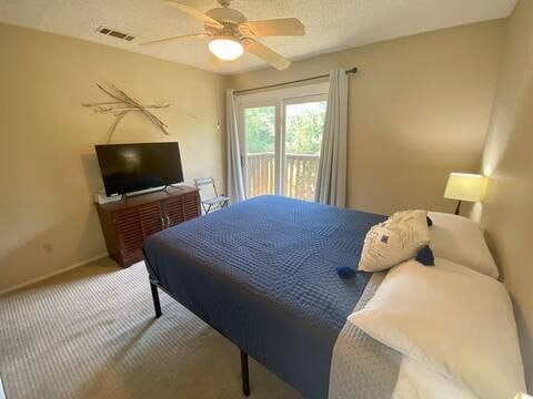 bedroom featuring access to exterior, visible vents, a ceiling fan, carpet flooring, and baseboards