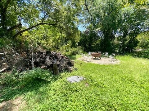 view of yard featuring an outdoor fire pit and a patio area