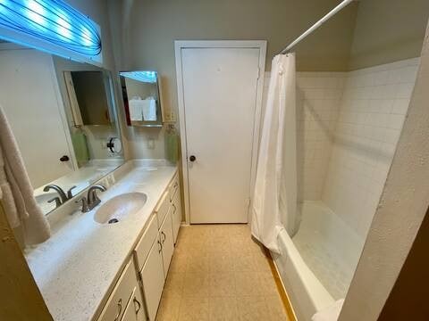 full bath featuring shower / tub combo and vanity