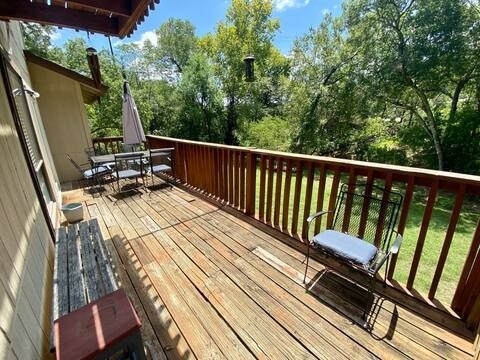 wooden terrace with outdoor dining area