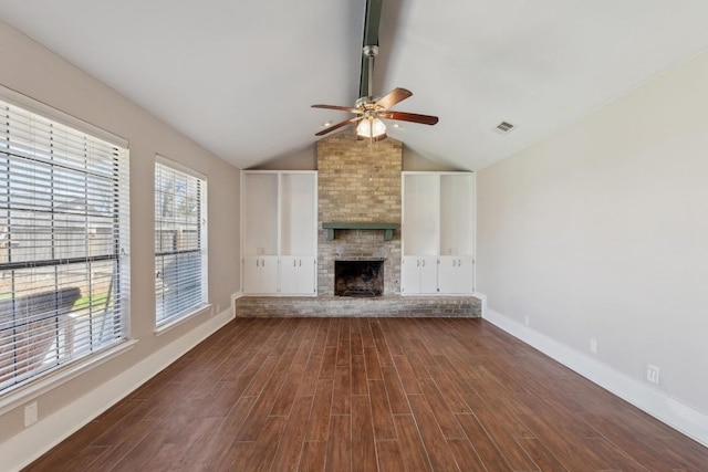 12810 Irongate Ave, Austin, TX 78727 - unfurnished living room featuring ceiling fan, dark wood-style flooring, and a large fireplace