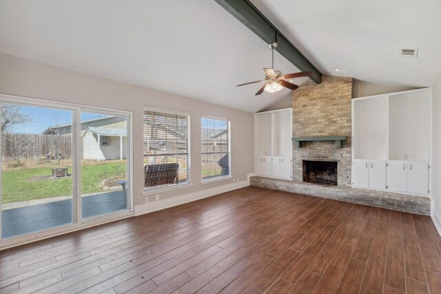 12810 Irongate Ave, Austin, TX 78727 - unfurnished living room featuring a ceiling fan, dark wood-type flooring, and healthy amount of natural light