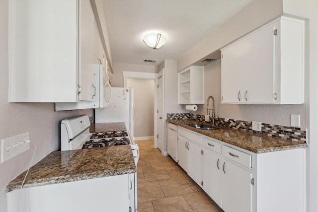 12810 Irongate Ave, Austin, TX 78727 - kitchen with white appliances, white cabinets, and backsplash