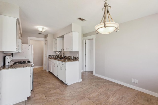 12810 Irongate Ave, Austin, TX 78727 - kitchen featuring white appliances, white cabinets, and dark stone countertops