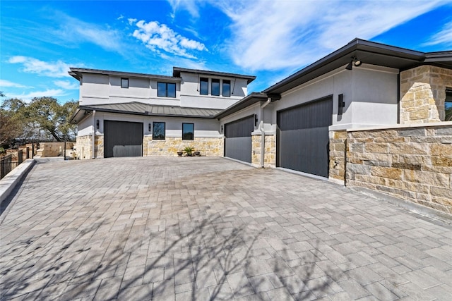 2923 Cliff Pt, Spicewood, TX 78669 - view of front facade featuring stone siding, a standing seam roof, and stucco siding