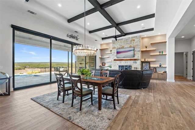 2923 Cliff Pt, Spicewood, TX 78669 - dining room with coffered ceiling, light wood finished floors, a stone fireplace, beamed ceiling, and recessed lighting