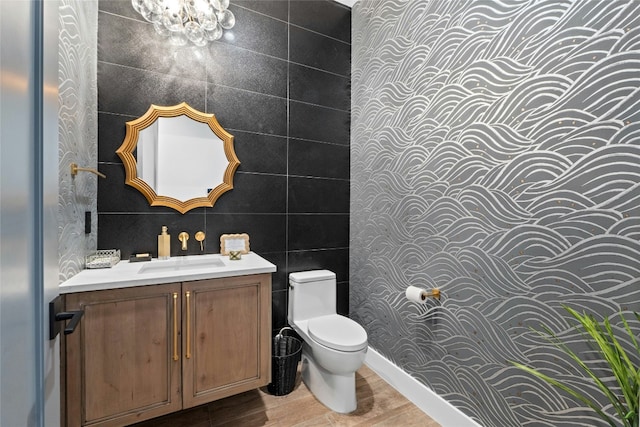 2923 Cliff Pt, Spicewood, TX 78669 - bathroom with toilet, wood finished floors, vanity, and a chandelier
