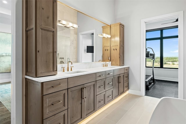 2923 Cliff Pt, Spicewood, TX 78669 - full bath with double vanity, baseboards, and a freestanding tub