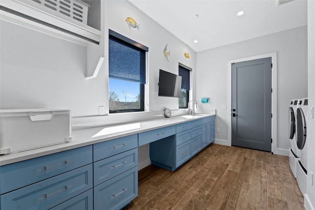 2923 Cliff Pt, Spicewood, TX 78669 - bathroom with separate washer and dryer, double vanity, wood finished floors, recessed lighting, and baseboards