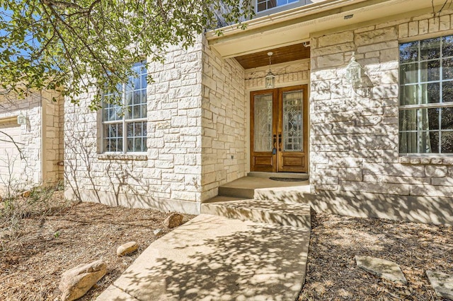 210 Amandas Way, Leander, TX 78641 - property entrance with stone siding and french doors