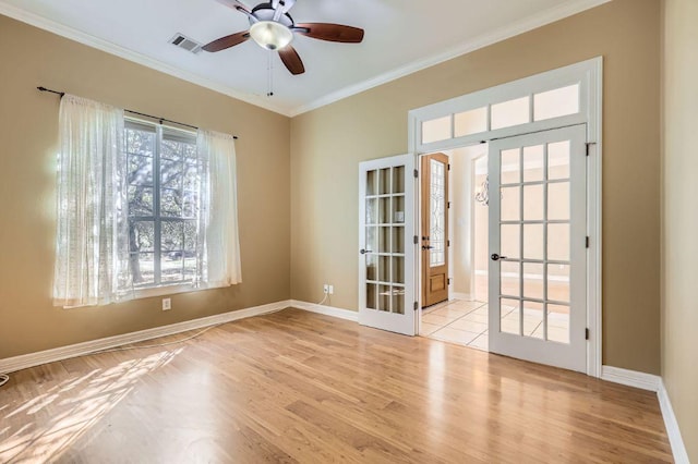 210 Amandas Way, Leander, TX 78641 - empty room featuring french doors, ornamental molding, wood finished floors, and ceiling fan