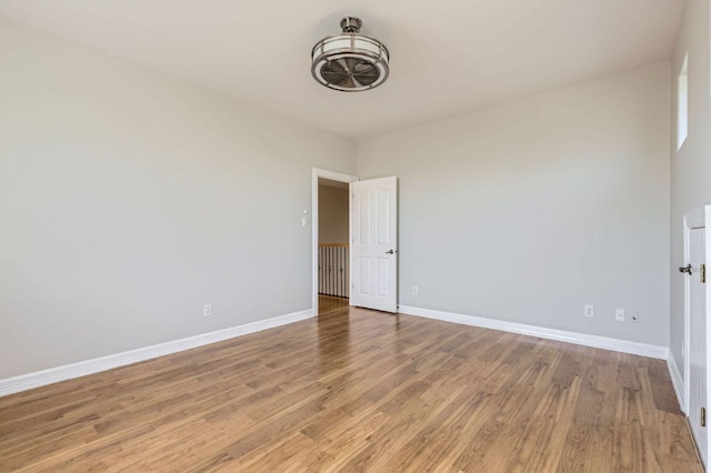 unfurnished room featuring light wood finished floors and baseboards