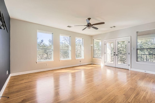 unfurnished room featuring baseboards, french doors, visible vents, and light wood-style floors