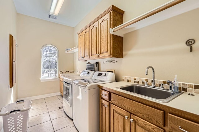 210 Amandas Way, Leander, TX 78641 - laundry room featuring washing machine and dryer, cabinet space, and light tile patterned flooring