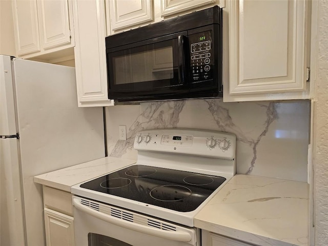 kitchen with white cabinetry, black microwave, decorative backsplash, and white electric range