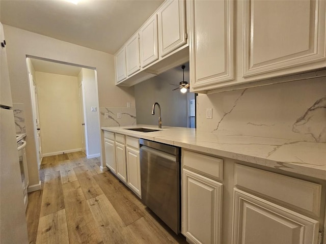 kitchen featuring decorative backsplash, ceiling fan, light wood-type flooring, stainless steel dishwasher, and a sink