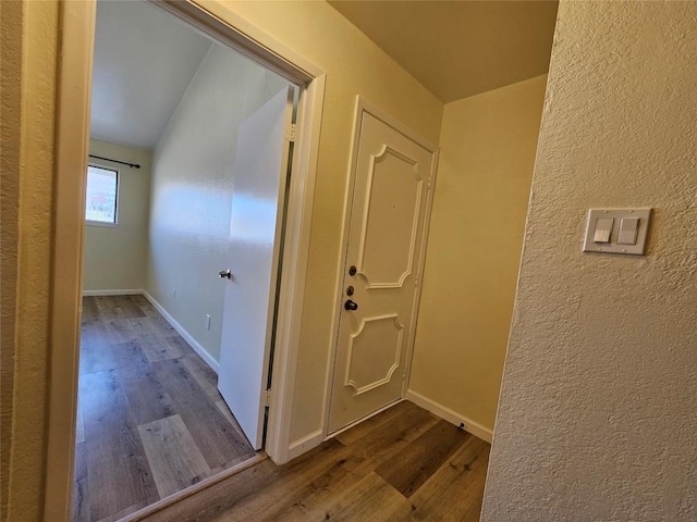 hallway with dark wood-style floors and baseboards