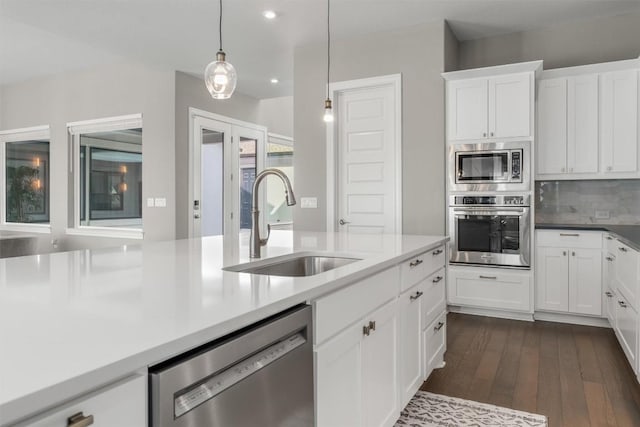 2201 Bel Paese Bnd, Leander, TX 78641 - kitchen with dark wood-style flooring, pendant lighting, a sink, stainless steel appliances, and recessed lighting