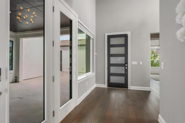 2201 Bel Paese Bnd, Leander, TX 78641 - entryway featuring baseboards, dark wood finished floors, and a towering ceiling