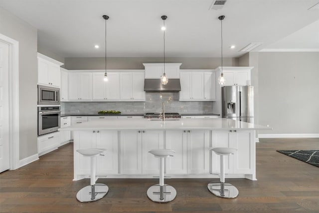 2201 Bel Paese Bnd, Leander, TX 78641 - kitchen with appliances with stainless steel finishes, decorative backsplash, under cabinet range hood, and dark wood-type flooring