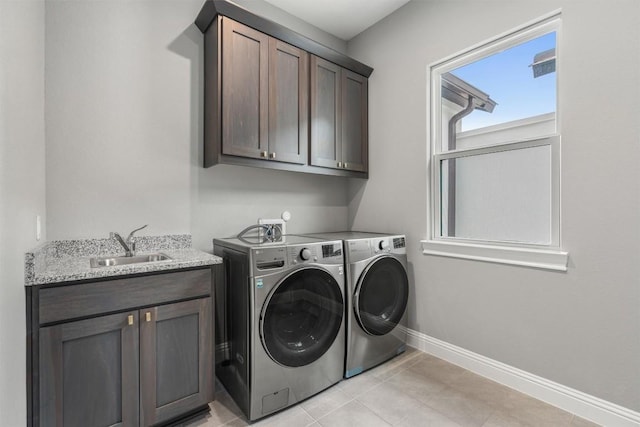 2201 Bel Paese Bnd, Leander, TX 78641 - laundry area with cabinet space, light tile patterned flooring, a sink, separate washer and dryer, and baseboards