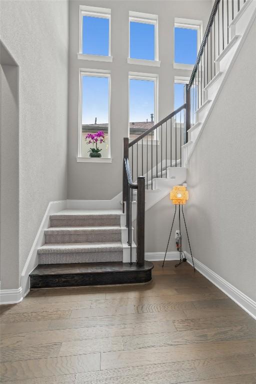 2201 Bel Paese Bnd, Leander, TX 78641 - staircase featuring baseboards and wood finished floors