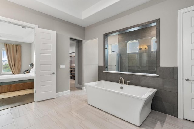 2201 Bel Paese Bnd, Leander, TX 78641 - ensuite bathroom featuring a freestanding tub, tile walls, tiled shower, and connected bathroom