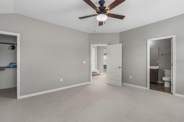 2201 Bel Paese Bnd, Leander, TX 78641 - unfurnished bedroom featuring lofted ceiling, baseboards, a spacious closet, carpet, and ensuite bath