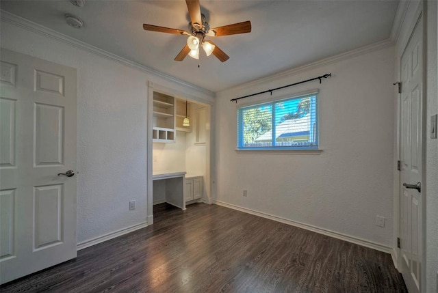 unfurnished bedroom featuring crown molding, dark wood finished floors, baseboards, and ceiling fan