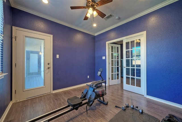 workout area featuring baseboards, visible vents, ornamental molding, wood finished floors, and french doors