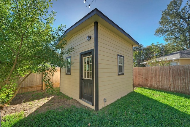 view of outbuilding with a fenced backyard and an outdoor structure