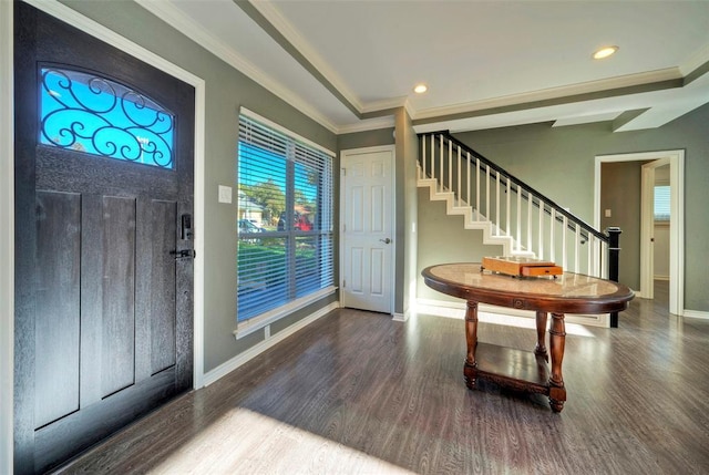 foyer with baseboards, stairway, wood finished floors, and ornamental molding