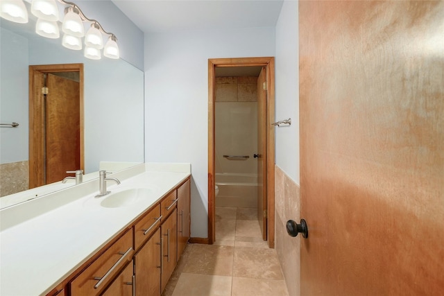 full bathroom featuring tile patterned flooring and vanity