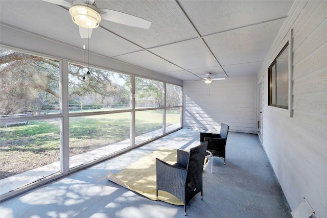 sunroom featuring a ceiling fan and a paneled ceiling