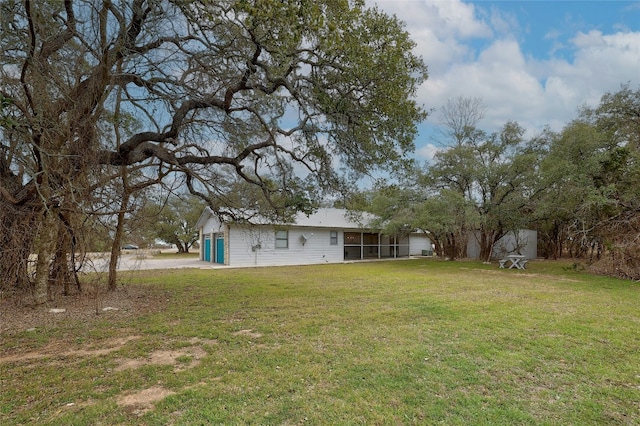 view of yard featuring a sunroom