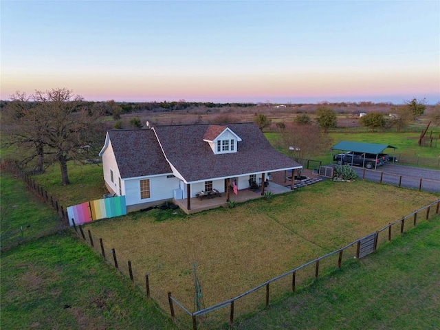 aerial view at dusk featuring a rural view