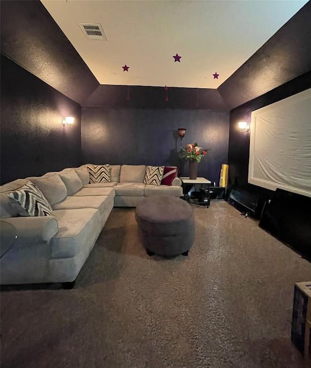 carpeted cinema room featuring visible vents
