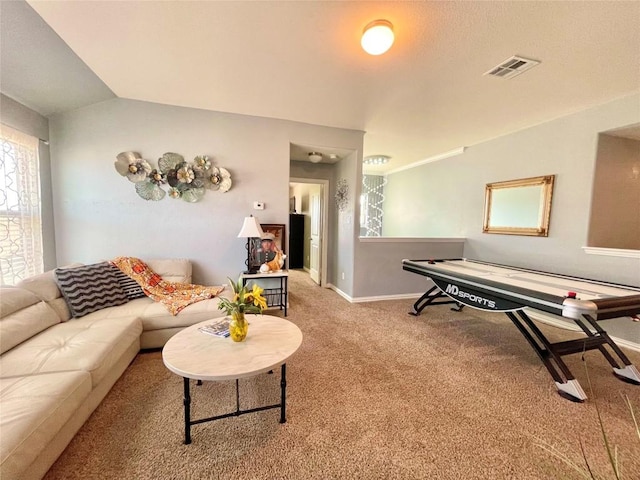 living room with vaulted ceiling, carpet, visible vents, and baseboards