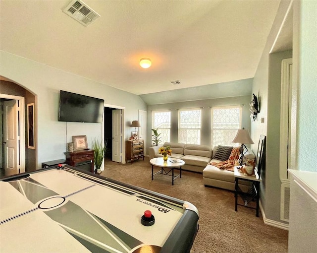 recreation room featuring lofted ceiling, visible vents, arched walkways, and carpet flooring