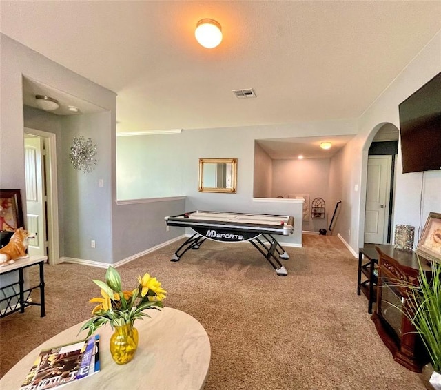 playroom featuring arched walkways, carpet floors, visible vents, and baseboards