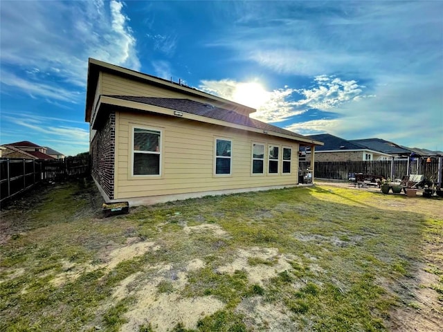 back of house with a patio, a yard, and a fenced backyard