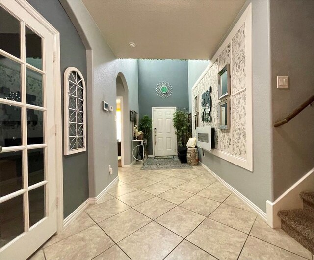 3707 Ozark Dr, Killeen, TX 76549 - foyer featuring arched walkways, light tile patterned flooring, and stairway