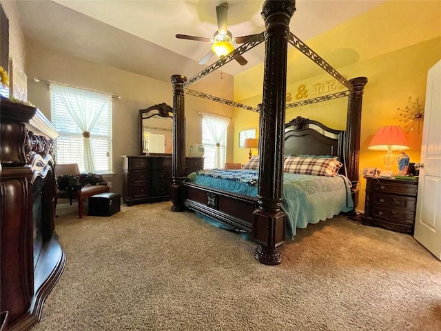 bedroom with carpet flooring, a ceiling fan, and vaulted ceiling